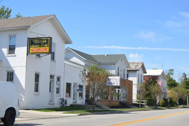 Buildings on the southern side of Main Street ( U.S. Route 35 ) west of Church Street in central New Lebanon , Ohio , United States .
