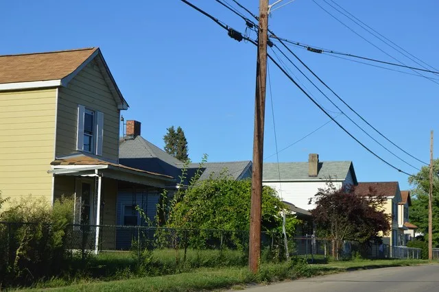 Houses on the northern side of Augspurger Avenue at the Highland Avenue intersection in New Miami , Ohio , United States .