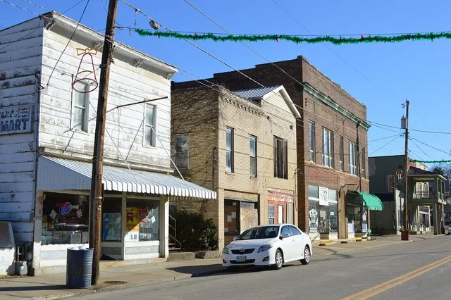 Commercial buildings on Main Street ( State Route 93 ) west of Clark Street in downtown New Straitsville , Ohio , United States .