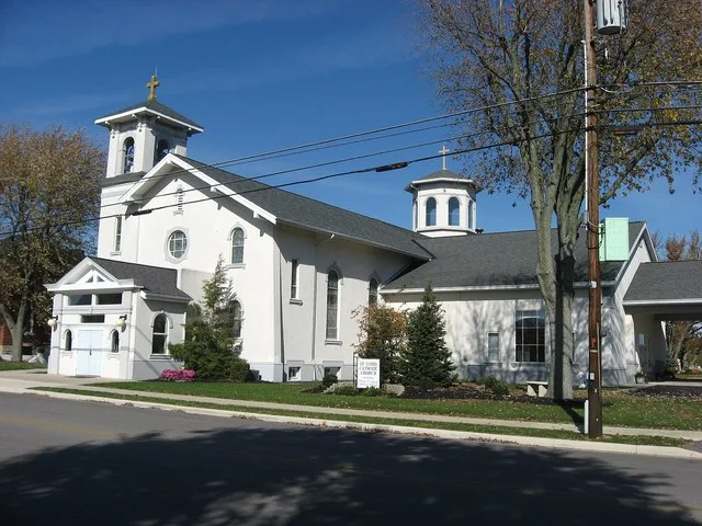 Front of St. Louis Catholic Church , located on North Star-Fort Loramie Road east of its junction with U.S. Route 127 in North Star , Ohio , United States . Built in 1914, the chu...
