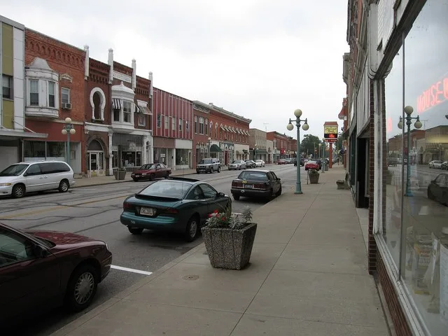 Photograph of the village of Oak Harbor , Ohio en , taken at street level from Water Street, looking East on state routes 105 / 163 toward Ohio State Route 19 .