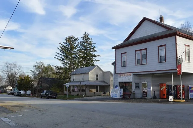 Buildings on the southern side of Cross Street ( U.S. Route 36 ) east of the Main Street intersection in Palestine , Ohio , United States .
