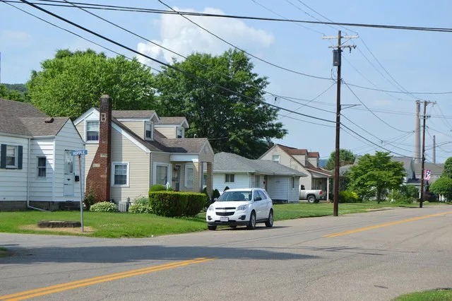 Houses on the southeastern side of Main Street at the Hopple Street intersection in Powhatan Point , Ohio , United States .