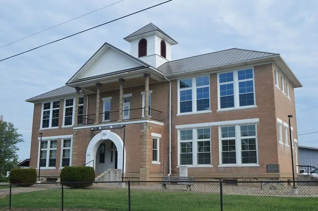 Front of the former Racine Public School (now the village hall), located at the intersection of Fifth ( State Route 124 ) and Main Streets in Syracuse , Ohio , United States . It...