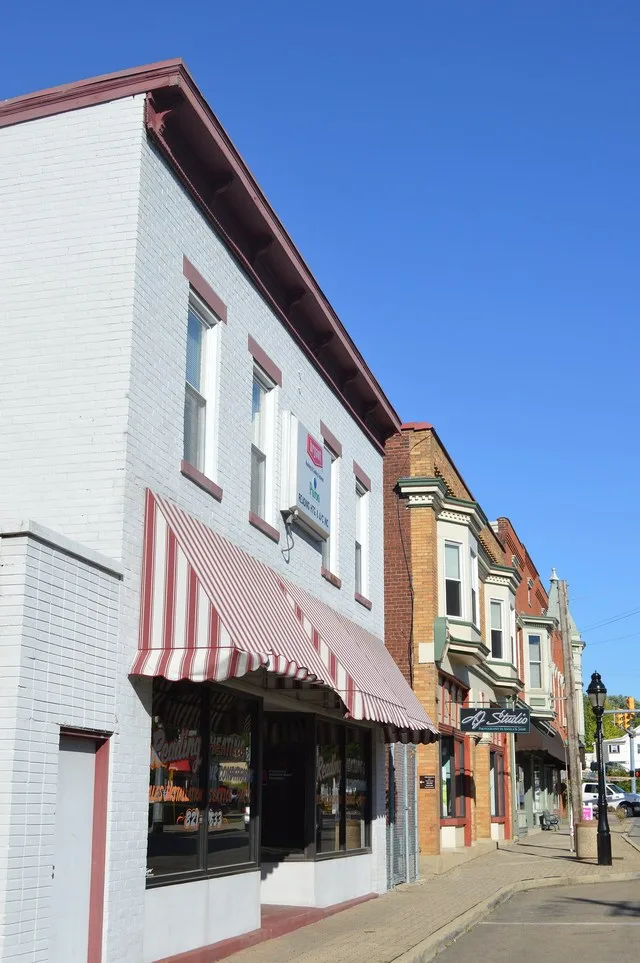 Buildings on the northern side of Benson Street, seen looking eastward from Lind Street, in Reading , Ohio , United States .