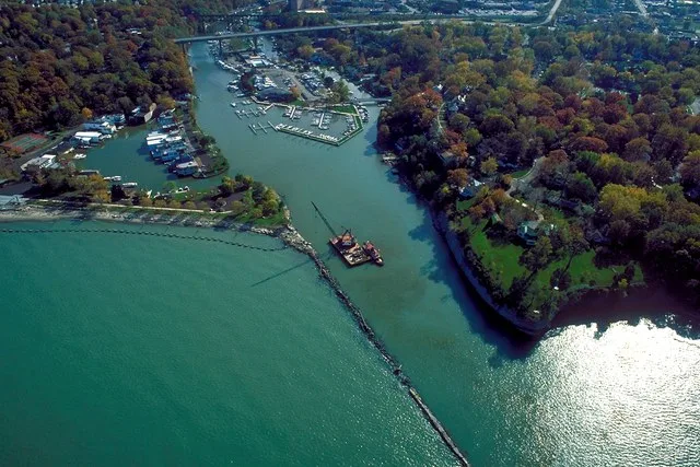 Aerial view of the harbor and river entrance at Rocky River, Ohio, USA on Lake Erie. The major highway U.S. Route 6 crosses the inlet on a bridge at the top of the picture. A derr...