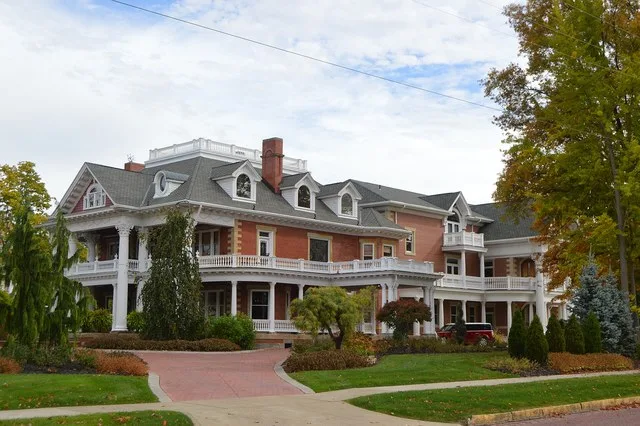 Western side and front of the Frank Sebring House , located at 385 W. Ohio Avenue in Sebring , Ohio , United States . Built in 1901, it is listed on the National Register of Histo...