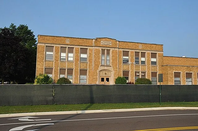 Constructed in 1939 and functioned as a high school until 1969 after which it became a middle school. It is now being renovated. It is completely surrounded by a green chain link...