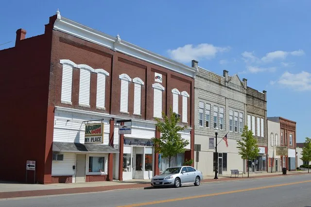 Buildings on the eastern side of Broadway Street ( State Route 66 ) seen looking south from Fourth Street ( State Route 117 ) in Spencerville , Ohio , United States .