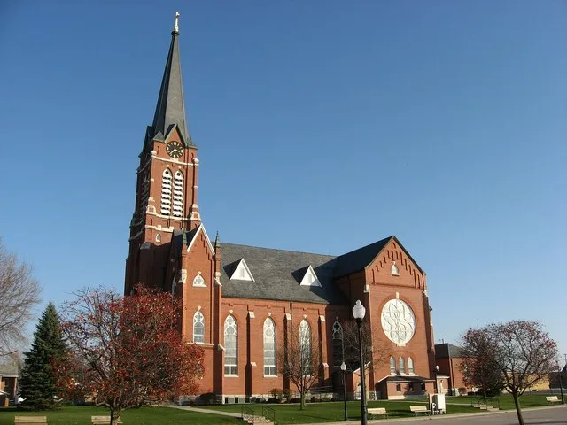 Western side of St. Henry Catholic Church , located along State Route 119 in St. Henry , Ohio , United States . Built in 1892, the church was listed on the National Register of Hi...