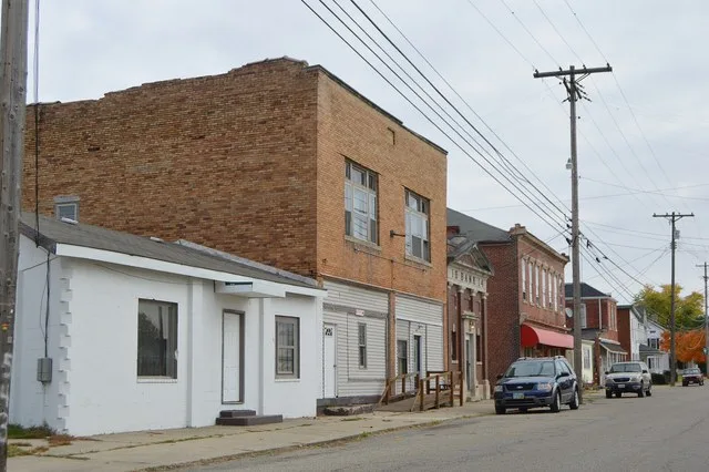 Buildings on the northern side of Main Street east of the former railroad crossing in Stoutsville , Ohio , United States .