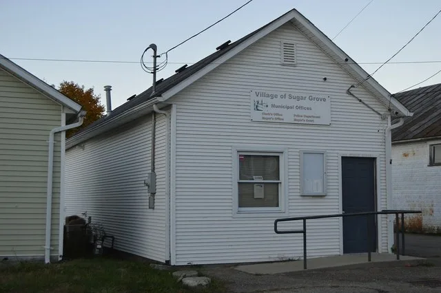 Front and western side of the Sugar Grove village hall, located at 101 Bridge Street in Sugar Grove , Ohio , United States .