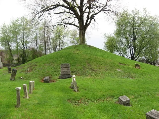 Eastern side of the Hodgen's Cemetery Mound , located in Hodgen's Cemetery off Walden Avenue in Tiltonsville , Ohio , United States . Built by the prehistoric Adena culture , it i...
