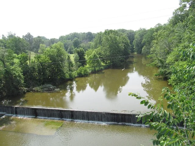 A dam on the Vermilion River , seen looking south from Main Street ( U.S. Route 20 ) in eastern Wakeman , Ohio , United States .