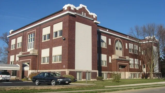 Southern side and front of the McKinley School , located at 240 S. Main Street in West Milton , Ohio , United States . Built in 1909, it is listed on the National Register of Hist...