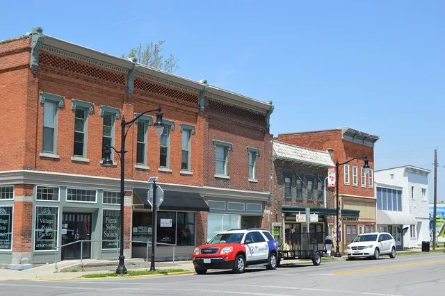 Buildings on the western side of Providence Street ( State Route 64 ) at the Waterville Street intersection in central Whitehouse , Ohio , United States . The nearest building, on...