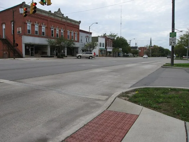Photograph of the village of Woodville , Ohio en , taken at street level from Main Street, looking North East on the concurrent routes of Ohio 105 and U.S. 20 .
