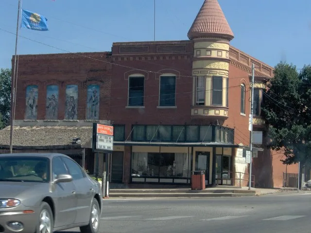 Front of the former Amphlett Brothers Drug and Jewelry Store , now the present day city hall — located at the intersection of Evans Avenue and U.S. Route 62 /Coblake Avenue, in Ap...