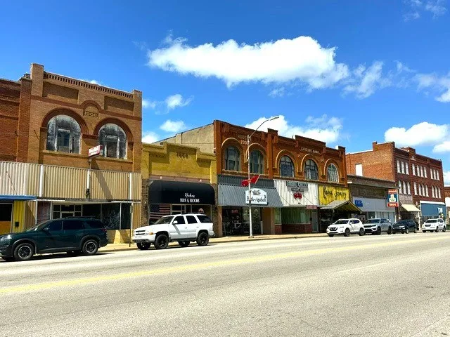 On Henryetta’s Main St, 6-2026, inc. (L-R) commercial buildings from 1909, 1908 & 1905; the Citizens Bank from 1904; & at far right, the Opera House from 1910.