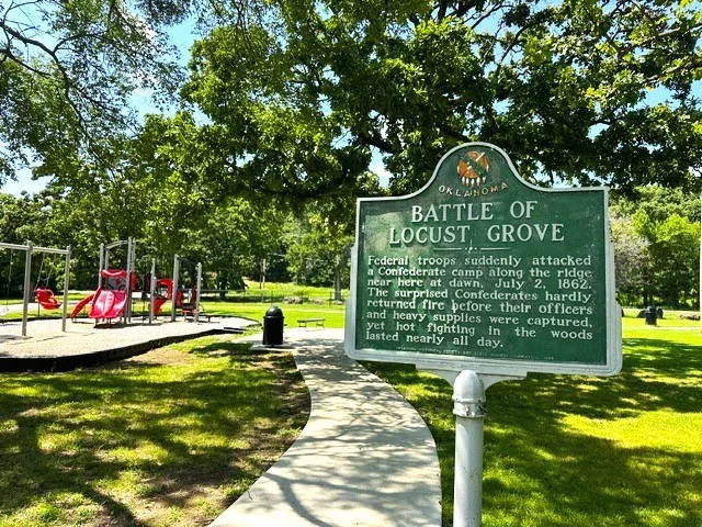 Sign in local park regarding the Battle of Locust Grove, as seen in July of 2026