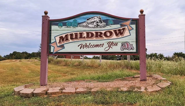 Municipal welcome sign on Oklahoma State Highway 64B in Muldrow, Oklahoma .