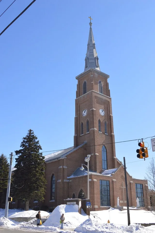 Front and northern side of St. Benedict's Catholic Church, located on the southeastern corner of the junction of Main ( U.S. Route 219 ) and Carroll Streets in Carrolltown , Penns...