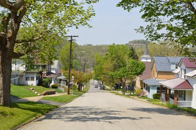 Looking downhill (northwest) on Sixth Street from the Walcott Street intersection in Clymer , Pennsylvania , United States . The street sign in the distance marks the Hancock Stre...
