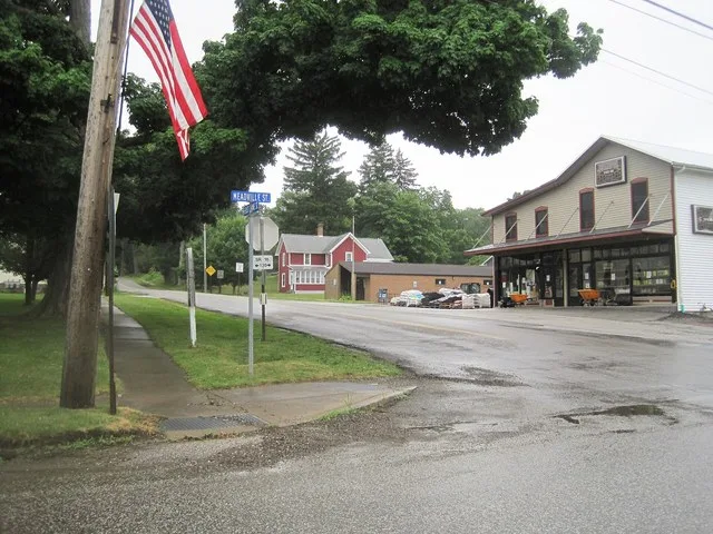 Photo looking east along East Crane Street in Cranesville , Pennsylvania from Pennsylvania Route 18 (Meadville Street). The borough post office and a hardware store are seen in th...