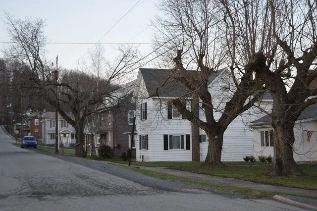 Houses along Hopkins Street, seen looking north from Rose Street, in Irvona , Pennsylvania , United States .
