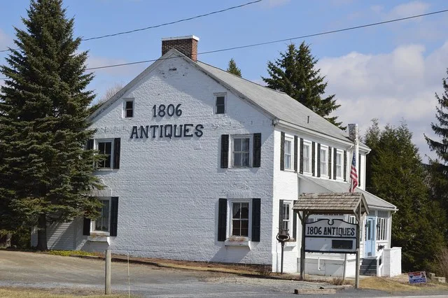 Western end and front of the John Dennison House, a former tavern on the Pennsylvania Wagon Road in Jennerstown , Pennsylvania , United States . Now the 1806 Antiques Shop located...