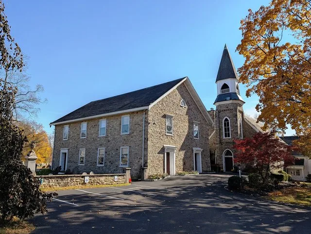 Photo of the New Britain Baptist Church in New Britain , Pennsylvania . Photo taken from U.S. Route 202 Business (East Butler Avenue) at Keeley Avenue looking south-southeast.