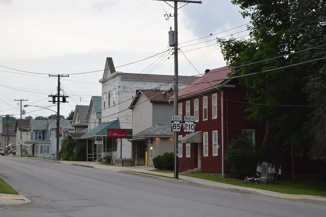 Buildings on the southeastern side of Main Street (Pennsylvania Routes 85 / 210 ) in the commercial district of Plumville , Pennsylvania , United States .