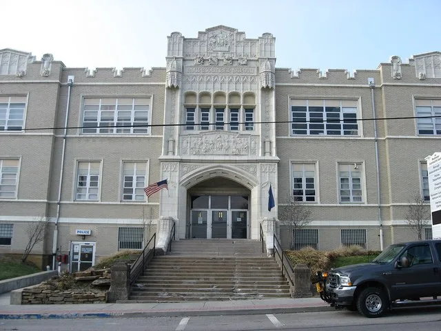 Entrance to the municipal building in Rochester , Pennsylvania , United States , located along Adams Street at the western corner of its intersection with Ohio Avenue.