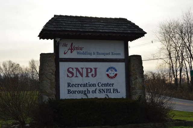 Large sign at the junction of Martin Road and Pennsylvania Route 108 welcoming passersby to the Slovene National Benefit Society recreational complex in S.N.P.J. , Pennsylvania ...