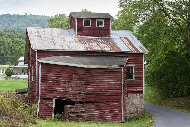 Hudson Grist Mill , the west side and shed addition, and the remains of a Fitz steel water wheel
