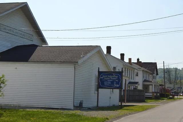 Houses and a Baptist church on the northeastern side of Main Street between Fourth and Third Streets in Shelocta , Pennsylvania , United States .