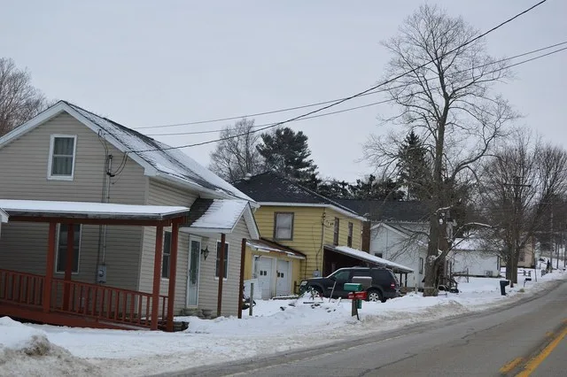 Houses on the western side of Main Street ( Pennsylvania Route 86 ) in southern Woodcock , Pennsylvania , United States .
