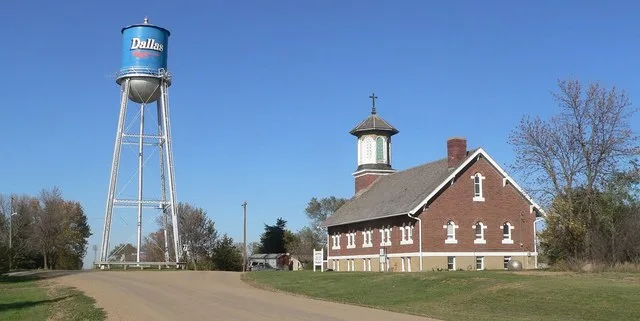 Downtown Dallas, South Dakota: camera is looking north along Main Street. The water tower is at the junction of 6th Street and Main; to the right (east) is St. Augustine Church, n...