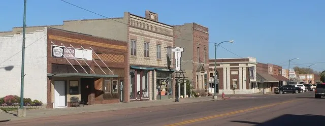 Downtown Gregory, South Dakota: west side of Main Street, looking northwest from about 6th Street. The building with the projecting "Old Pioneer" sign is the Tackett-Underwood bui...