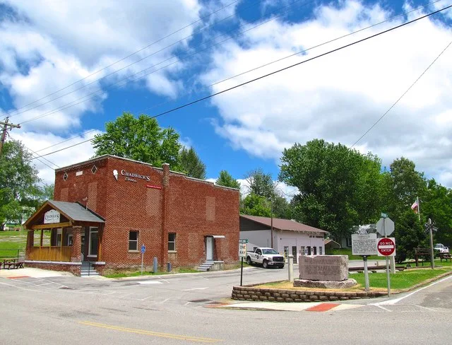 Buildings and historical markers at the intersection of College Avenue and Homecoming Circle in Friendsville, Tennessee, United States.