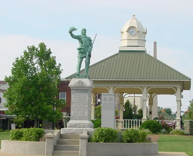 This photograph is of the town square in Lawrenceburg, TN with a statue of David Crockett in the center.