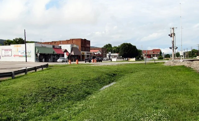Spring City, Tennessee, United States. Storefronts along Front Street are on the left, and the Norfolk Southern tracks are on the right. The Spring City depot is in the distance o...