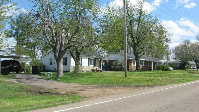 Houses on the eastern side of Thompson Street ( State Route 5 ) south of the Jones Street intersection in Woodland Mills , Tennessee , United States .