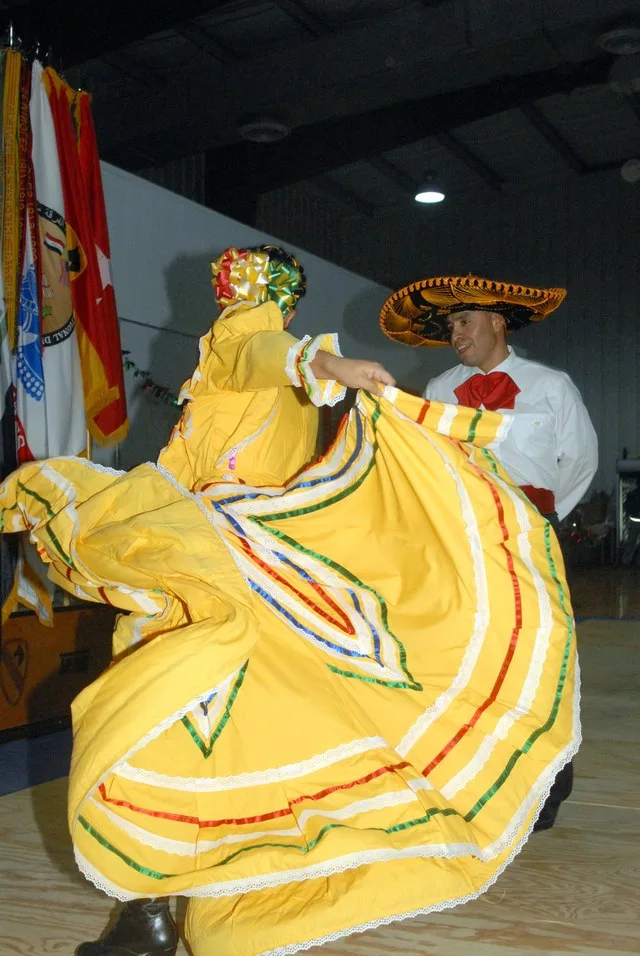 CAMP LIBERTY - Staff Sgt. Alma Selvera (left), of Oklahoma City, Oklahoma, and Sgt. 1st Class Frank Rodriguez, of San Marcos, Texas, perform a traditional Jalisco Mexican dance as...