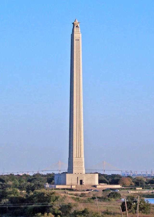 Photo of the San Jacinto Monument taken from the Battleship Texas in Fall 2006. The Fred Hartman Bridge is visible in the background.