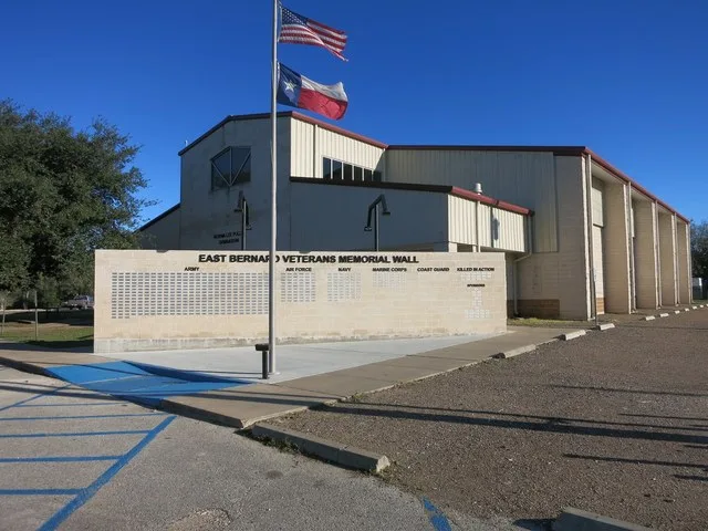 Photo shows the Veterans Memorial at the Norma Lee Pullen Gymnasium at Leveridge St, East Bernard, TX 77435. View is toward the southeast.