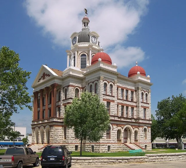 The Coryell County Courthouse in Gatesville, Texas, United States. The courthouse was built in 1897-1898 out of limestone and red sandstone. The courthouse and surrounding histori...