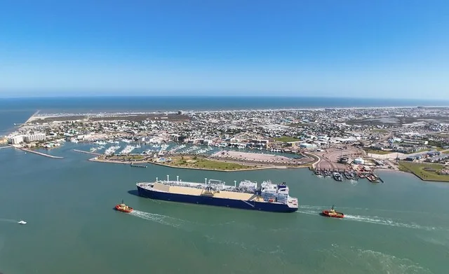 Aerial view of Port Aransas, Texas with an LNG carrier ship passing through
