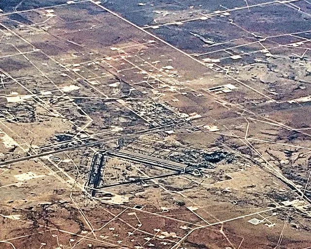 Aerial photo of Pyote, Texas looking northeast. The triangle shape is the remnants of a WWII Air Force training facility with the town above the triangle in the photo.