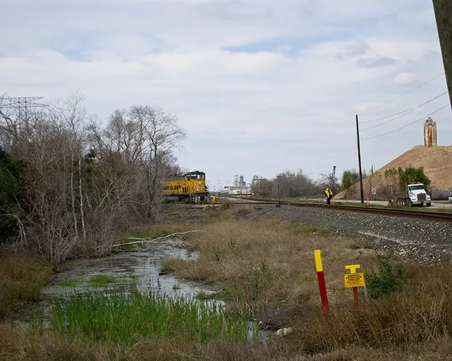 The locomotive in this photo is pulling another locomotive and nothing else. This is in the area of the Bayport Industrial District, which includes a large number of refineries an...